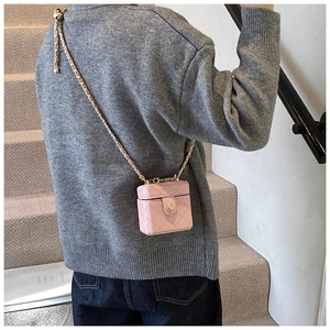 Pink quilted leather mini vanity bag with golden chain strap shown from a back view