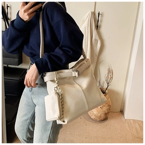 Creamy white oversized leather tote bag with matching coin pouch and buckle details
