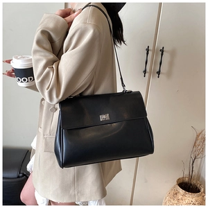Close-up of black leather briefcase with silver turn-lock and elegant texture