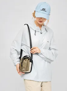 Detail of cargo style crossbody bag showing khaki nylon fabric and drawstring closure