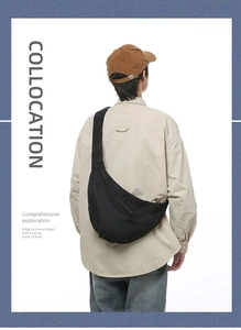 Detailed back view of a black crescent crossbody bag with an adjustable wide strap
