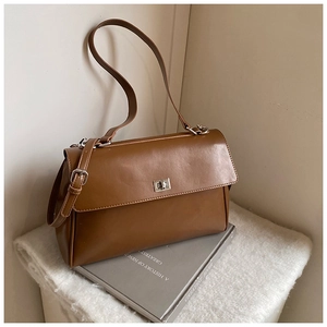Detailed view of the brown vintage tote with silver metal twist lock and dual strap options