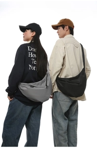 Detail of grey and black nylon crescent crossbody bags with adjustable straps