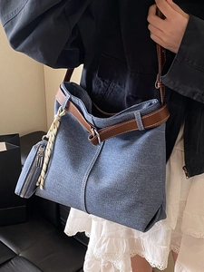 Vintage blue denim tote bag with brown leather straps and small side pouch