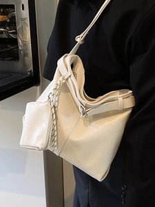 Large off-white PU leather tote bag with small pouch shown on a model for daily commute
