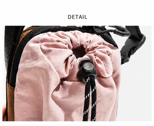 Close-up of pink nylon crossbody bag showing the black drawstring closure and toggle detail