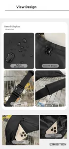 Detail view of black waterproof nylon crossbody bag showing zippers and buckles