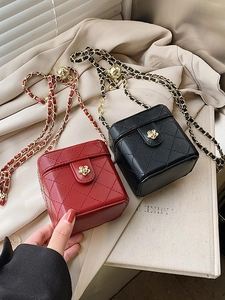 Mini quilted leather crossbody bags in red and black with gold flower clasps and chain straps