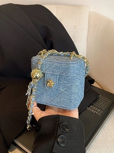 Mini denim blue crossbody box bag with gold chain strap and quilted diamond pattern