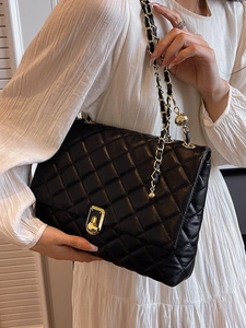 Quilted black leather shoulder bag with gold chain strap and square metal lock closure