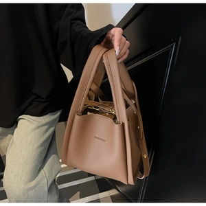 Detail of brown litchi pattern leather handbag featuring HAMIROO embossed branding