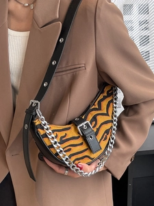 Tiger pattern crescent moon shoulder bag with silver chain and black leather strap detail