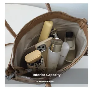 Top view of brown bucket bag interior showing large capacity for phone and cosmetics
