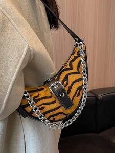Tiger print crescent shoulder bag with silver chain and leather strap on model