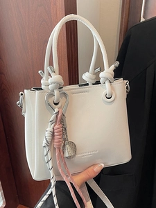 Chic white oil wax leather bucket bag with heart and badminton charms for daily commuting