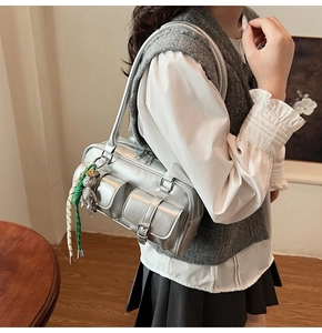 Silver matte Boston bag featuring functional front flap pockets and a cute bear charm accessory