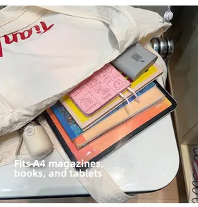 Macro view of beige nylon tote bag interior showing capacity for A4 magazines and tablets