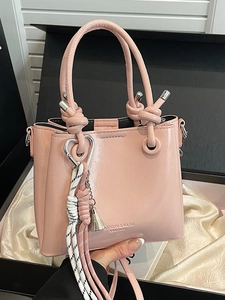 Pink vintage oil wax leather bucket bag with unique knotted handle and fashion tassel