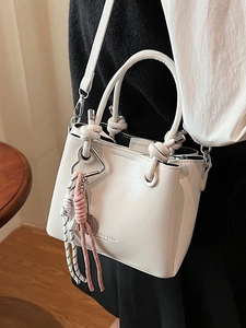 Retro white glossy bucket bag with knotted handle and heart charm pendant