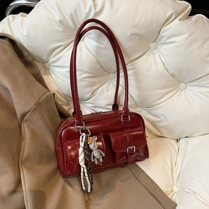 Elegant wine red boston shoulder bag with metallic pocket buckles and bear pendant charm