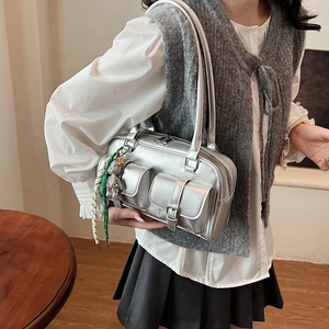 Metallic silver Boston underarm bag with utilitarian buckle pockets and metal bear charm