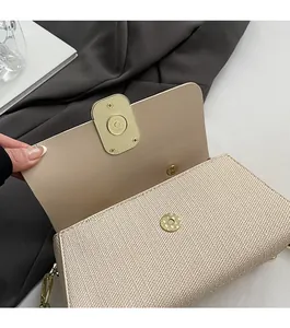 Detail of the magnetic buckle closure and woven texture on a beige square handbag