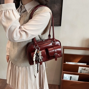 Vintage burgundy underarm Boston bag in glossy waxed leather with chic teddy bear charm