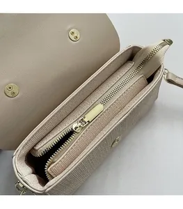 Detail of beige shoulder bag showing smooth zipper and gold magnetic closure for security
