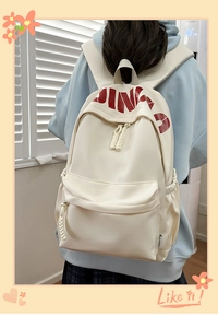 Detail of white casual backpack with red DING lettering and braided rope zipper