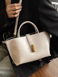 Minimalist white oil wax leather bucket bag with golden buckle and crossbody strap