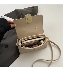 Spacious interior of beige pebbled leather crossbody bag with compartments for essentials