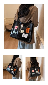 Detail der glänzenden schwarzen Tote Bag mit Retro-Patches und Schulterriemen im Uni-Stil