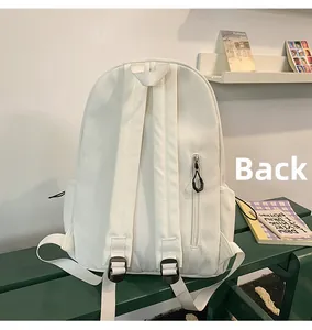 Detail of the white backpack back panel featuring a hidden zipper pocket and adjustable straps