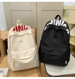 Detail of the high-capacity casual backpack featuring letter print and braided zipper pullers
