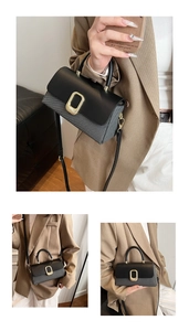 Detailed close-up of a two-tone crossbody bag featuring leather lid and canvas body
