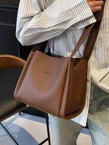 Brown lychee leather bucket bag with embossed logo and golden feet for women's fashion