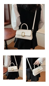 Detail view of white crossbody bag with woven texture and gold metal buckle closure