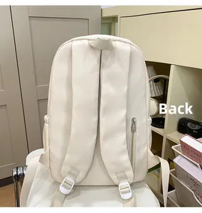 Back view of minimalist beige backpack featuring padded shoulder straps and hidden side pocket