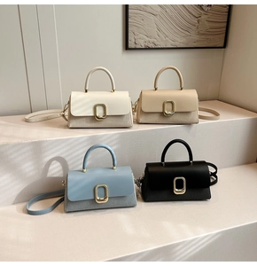 Detail of four stylish mini square bags in white beige blue and black with woven texture