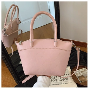 Detailed macro view of pink textured PU leather bucket bag with silver zipper and handles