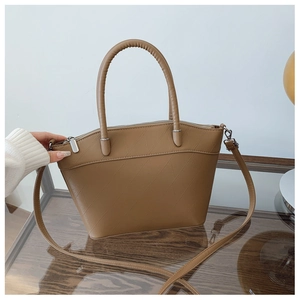 Detail of khaki PU leather bucket bag with diagonal embossed texture and metal zipper