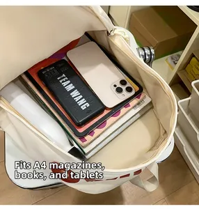Detail view of spacious cream backpack interior showing A4 magazines and tablet storage