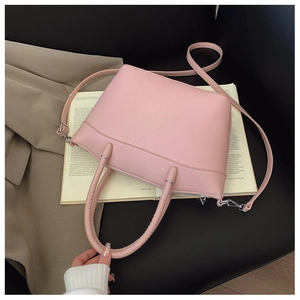 Detailed close-up of light pink bucket bag with geometric quilted stitching and silver hardware