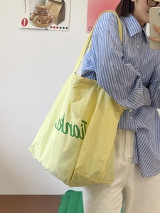 Minimalist light yellow nylon tote bag with green Thanks print for casual daily commuting