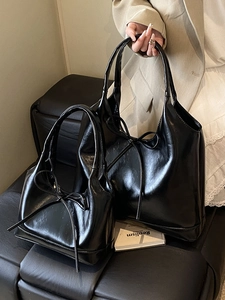 Polished black oil wax leather tote bag set featuring stylish decorative bow accents