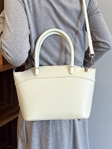 Minimalist beige bucket bag with geometric texture and detachable strap for women
