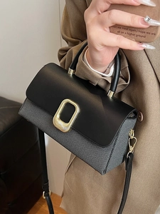 Elegant two-tone tote bag with black flap and grey textured body held by a model