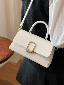 Elegant beige woven crossbody bag with gold metallic buckle and leather top handle