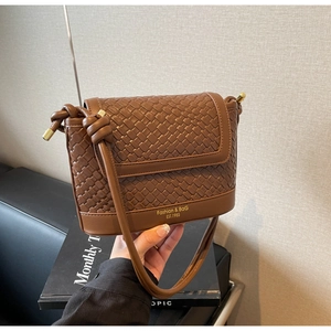 Détail du sac seau en cuir tressé marron foncé avec logo doré Fashion et Bag