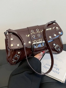 Punk style dark red patent leather shoulder bag with decorative metal eyelets and buckles